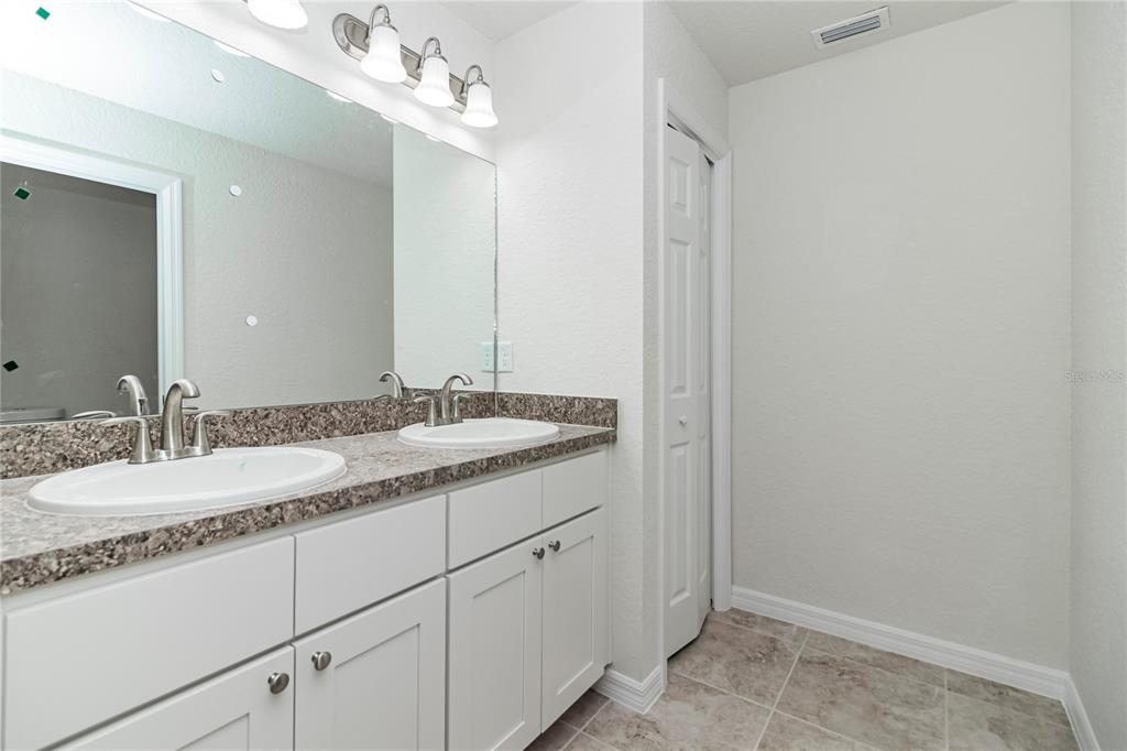 61 Larch Run Ocala, FL 34480 - Photo 15 of 26 a bathroom with a granite countertop sink and a mirror