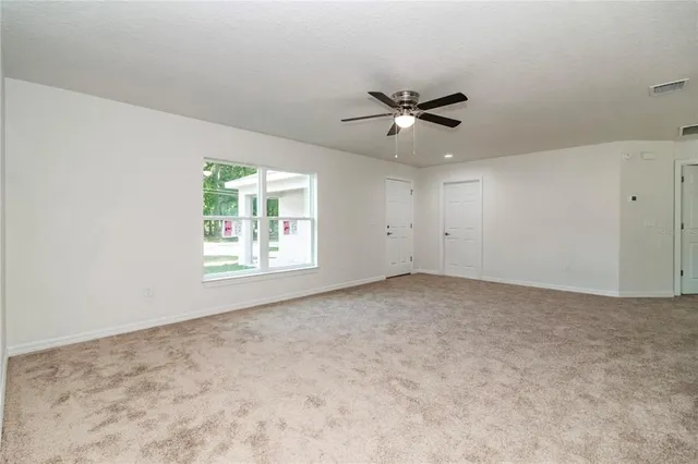 a view of an empty room and a window