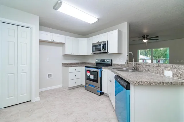 a kitchen with stainless steel appliances granite countertop a stove and a sink