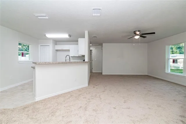 a view of a kitchen with a sink and cabinets
