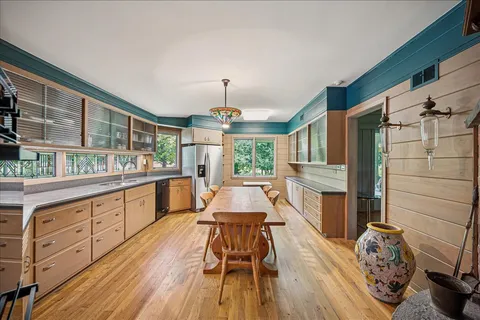 a kitchen with wooden floors a sink and a stove