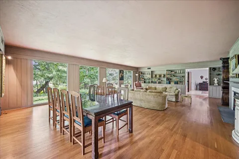 a dining room with furniture and wooden floor