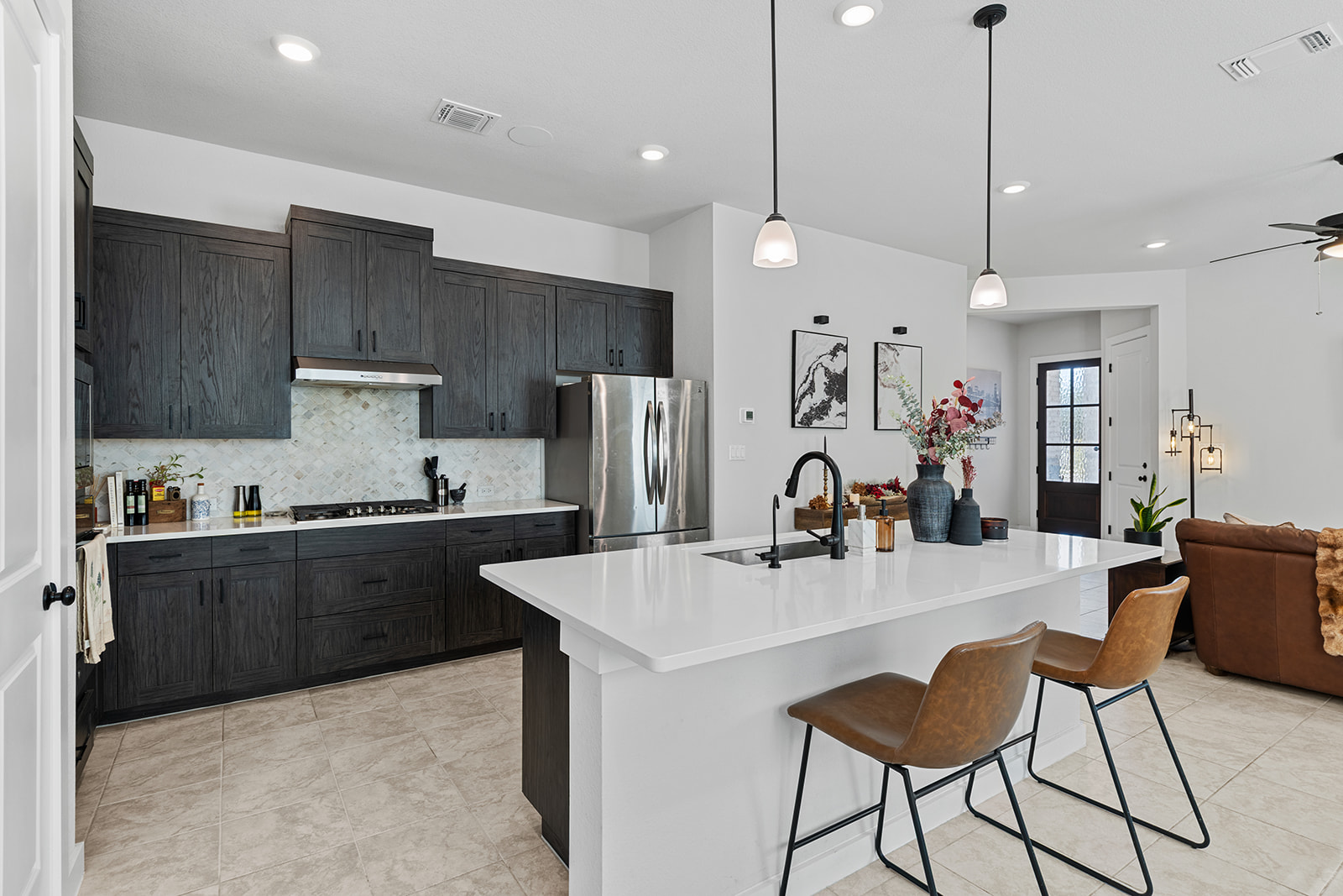 972 Leaning Oak Lane Georgetown, TX 78628 - Photo 32 of 33 a kitchen with stainless steel appliances granite countertop a refrigerator a sink dishwasher a dining table and chairs with wooden floor