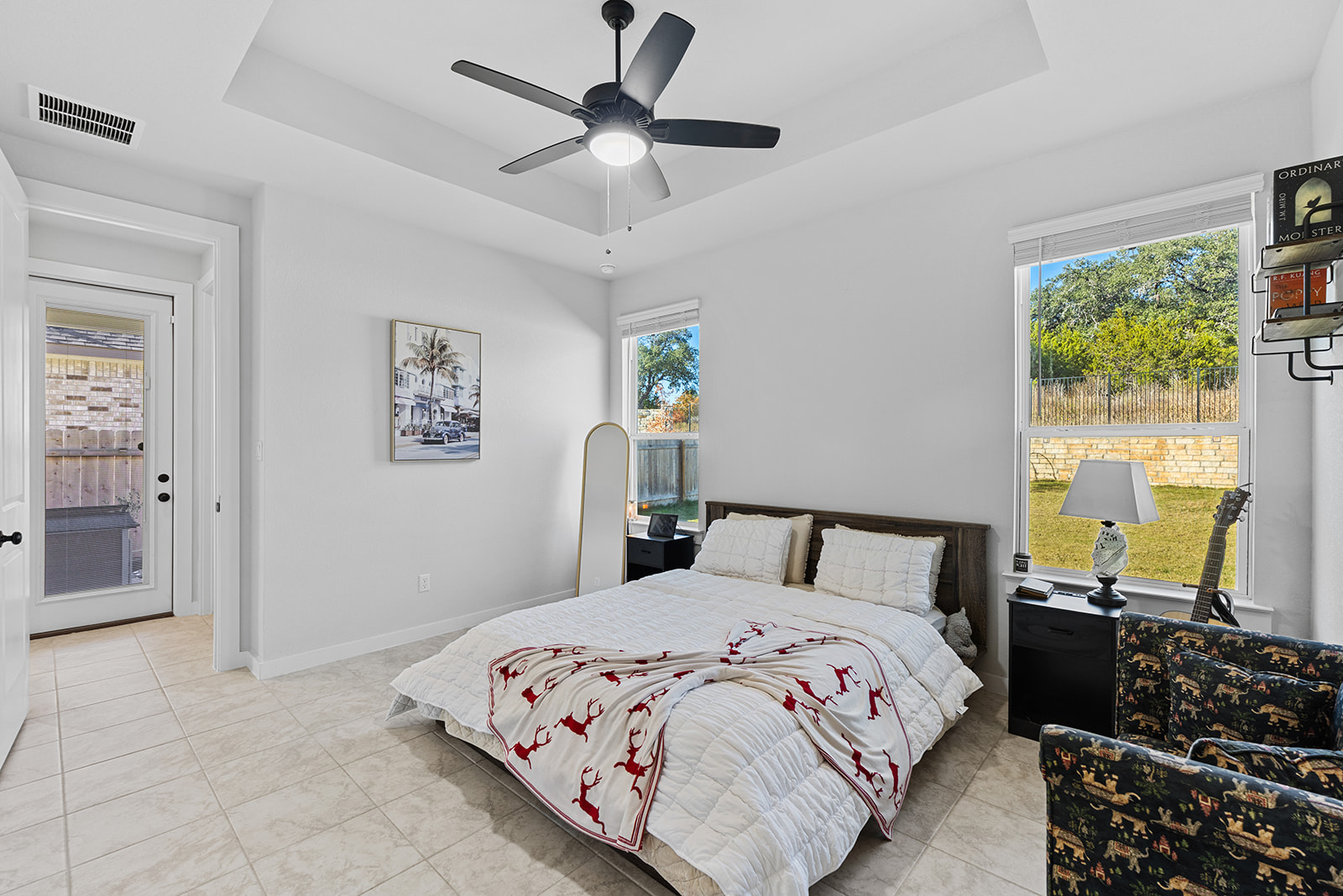 972 Leaning Oak Lane Georgetown, TX 78628 - Photo 13 of 33 a bedroom with a bed and a chandelier