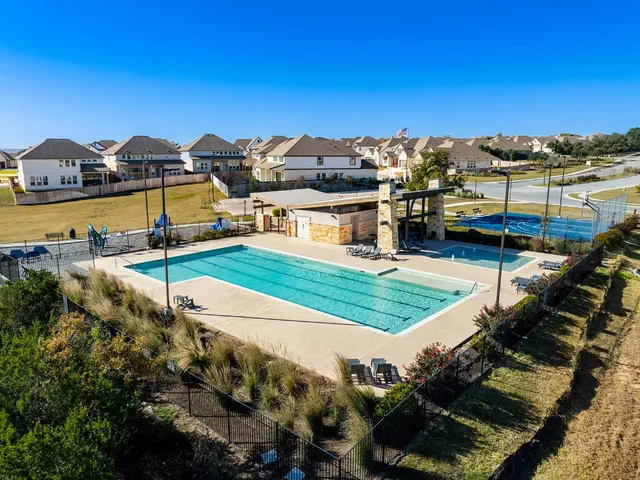 an aerial view of a house with swimming pool outdoor seating