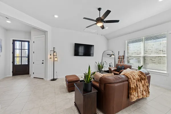 a living room with furniture fireplace and a large window