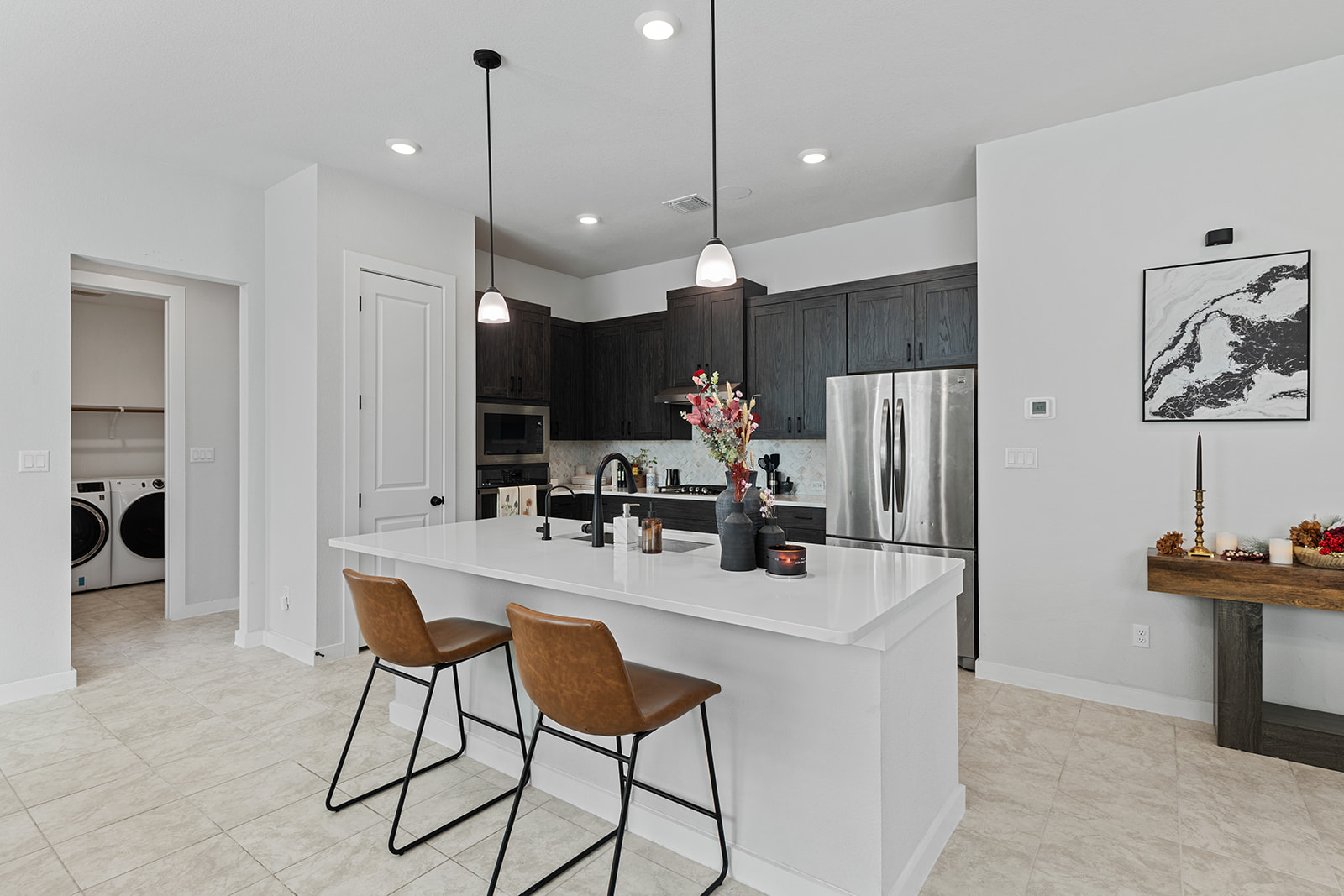 972 Leaning Oak Lane Georgetown, TX 78628 - Photo 8 of 33 a kitchen with a refrigerator a dining table and chairs