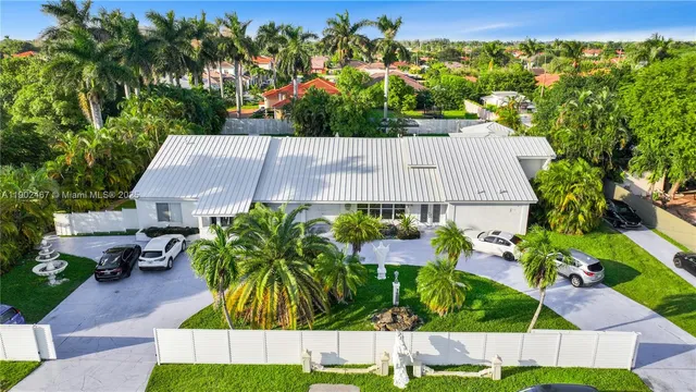 a view of a garden with plants and large trees