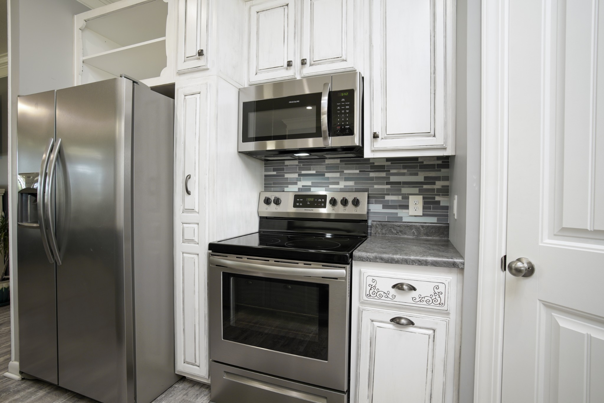 108 Eagle Drive Waynesboro, TN 38485 - Photo 9 of 29 a kitchen with stainless steel appliances granite countertop a stove microwave and refrigerator