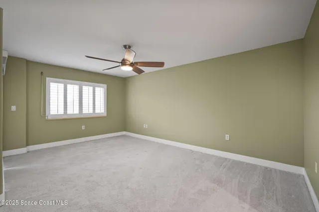 a view of a livingroom with a ceiling fan and window