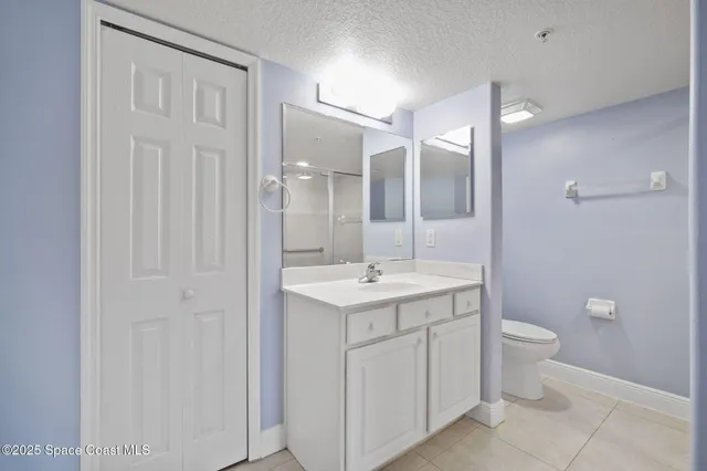 a bathroom with a glass shower door
