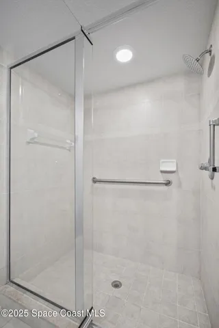 an empty room with windows and ceiling fan