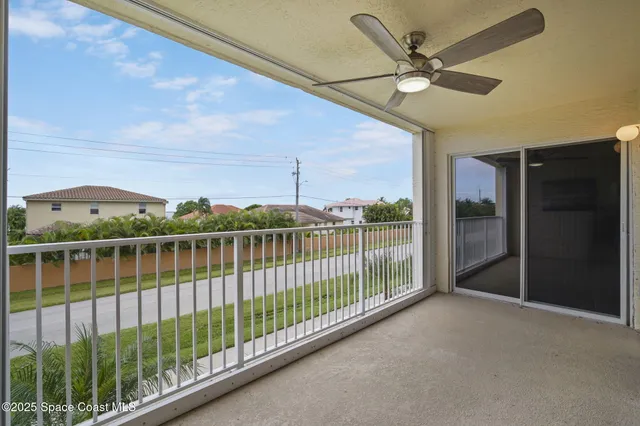 a view of a livingroom with a ceiling fan and window