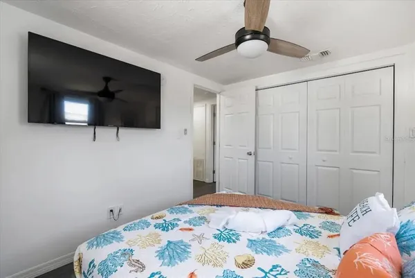 a bedroom with a bed and a flat screen tv