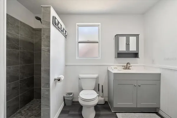 a bathroom with a toilet sink and mirror
