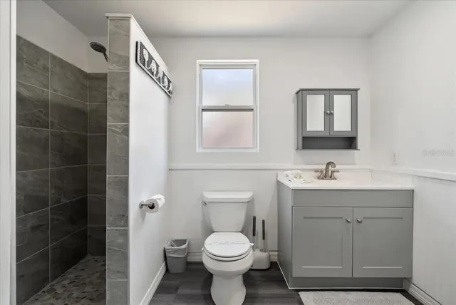 a bathroom with a toilet sink and mirror