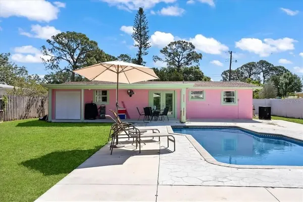 a view of a house with backyard sitting area and garden