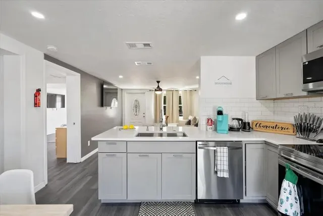 a kitchen with a sink cabinets and wooden floor