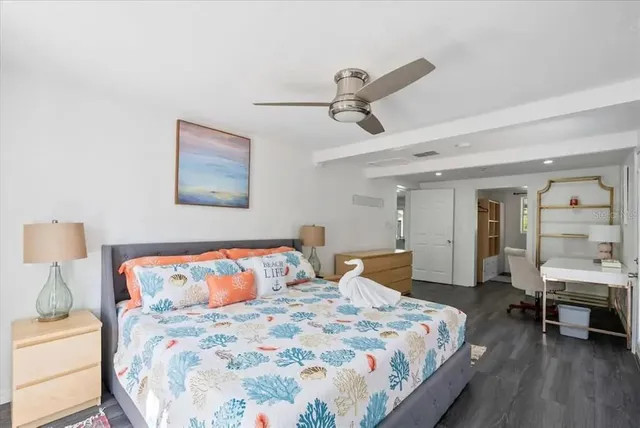 a bedroom with a large bed and a table