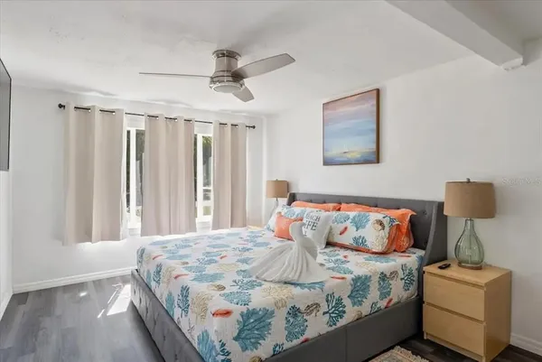 a bedroom with a bed and a chandelier