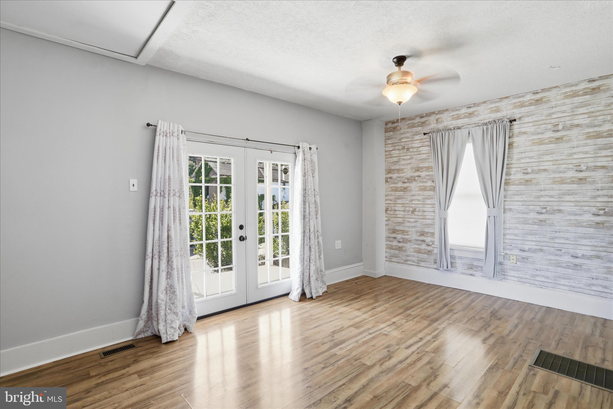 21 Sharpless Street Keyser, WV 26726 - Photo 5 of 33 a view of an empty room with wooden floor and a window