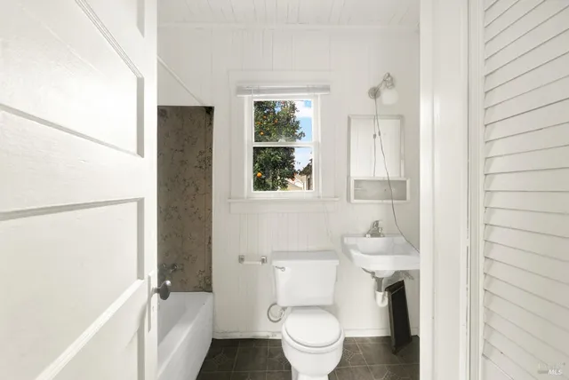 a bathroom with a toilet a sink and a bathtub