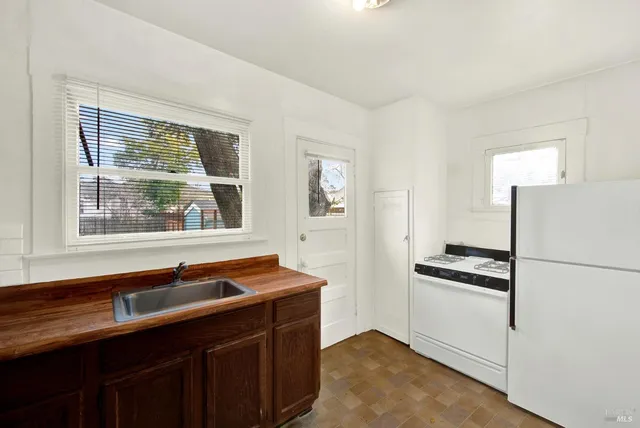 a kitchen with a refrigerator and a sink