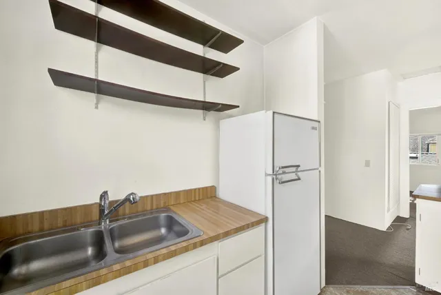 a kitchen with a refrigerator and a sink