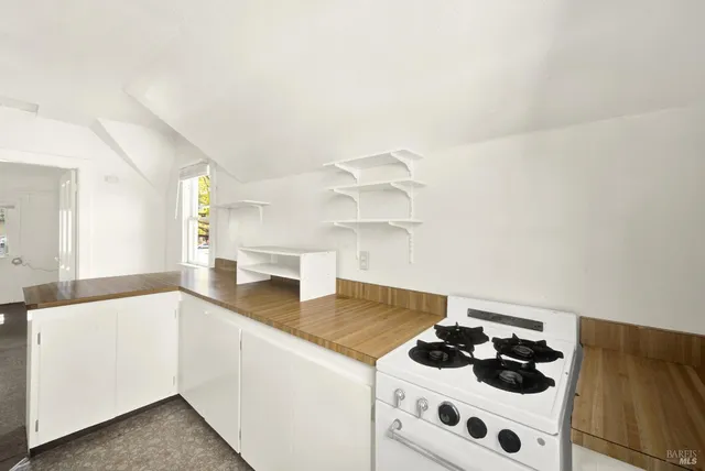 a kitchen with a cabinets and white appliances