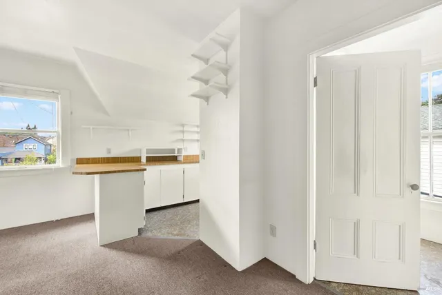 a kitchen with white cabinets and white appliances