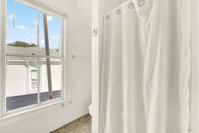 a view of a backyard with a garden and entertaining space