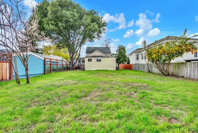 an aerial view of a house with a yard basket ball court and outdoor seating