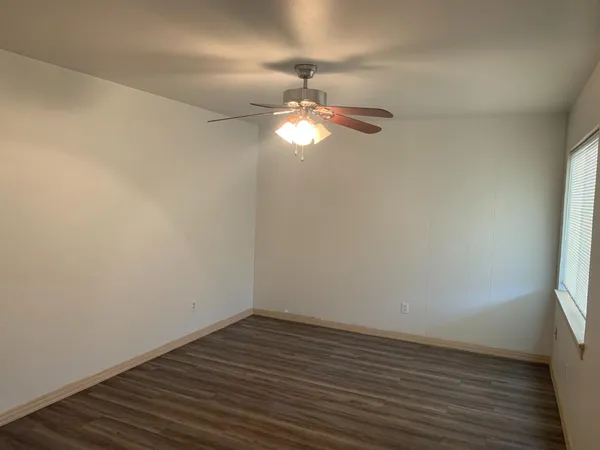 a view of a room with wooden floor cabinets and a window