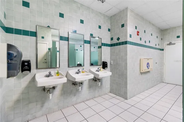 a view of a hallway with white walls and door