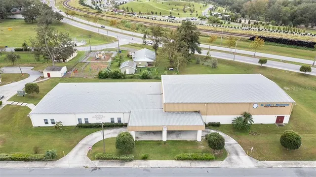 an aerial view of a house with a yard and lake view