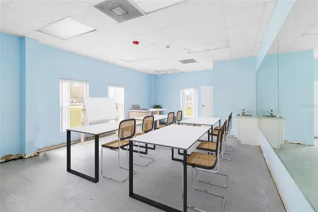 a bathroom with a toilet mirror and vanity
