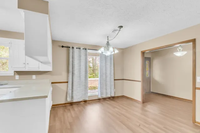 a view of a kitchen with a sink and a refrigerator