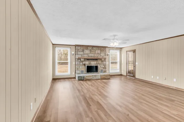 wooden floor in an empty room with a fireplace