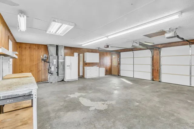 a view of an empty room with closet and windows