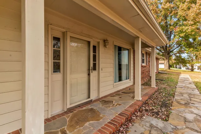 a view of a brick house with a large window