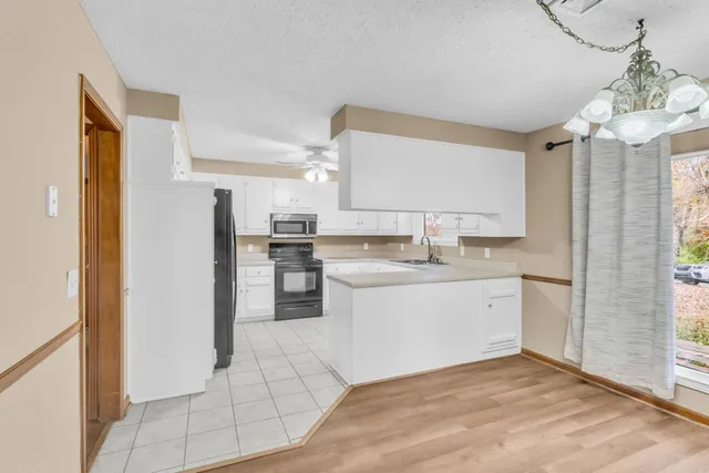 a kitchen with a sink cabinets and refrigerator