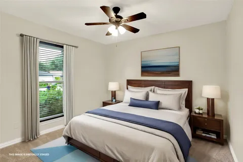 a bedroom with a bed and a large window