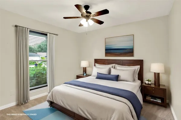 a bedroom with a bed and a large window