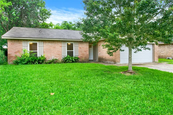 a front view of a house with a garden and yard