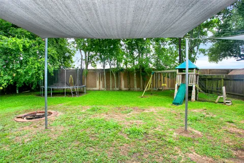 a backyard of a house with lots of green space and fountain
