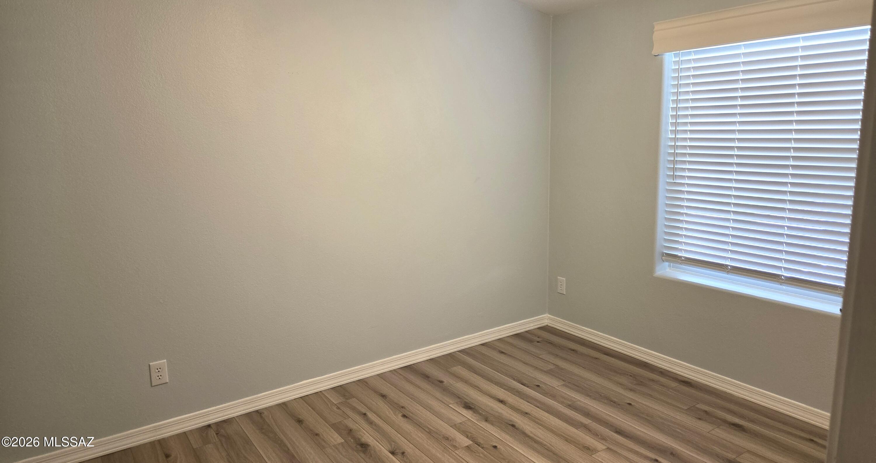 1030 Barrel Cactus Ridge, Unit 118 Benson, AZ 85602 - Photo 14 of 22 a view of a room with wooden floor and a window