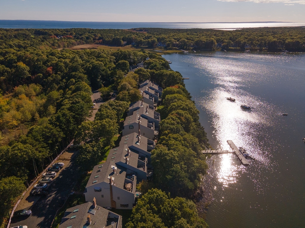 381 Great Oak Road, Unit 9 Mashpee, MA 02649 - Photo 38 of 42 an aerial view of a houses with a lake