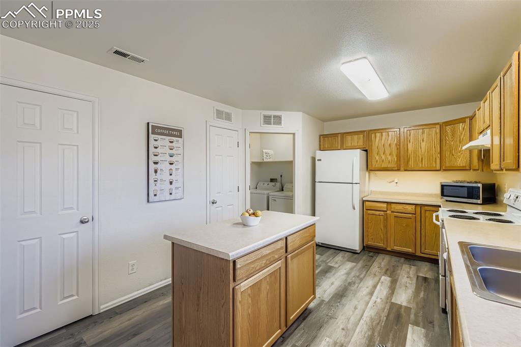 283 Ellers Grove Colorado Springs, CO 80916 - Photo 7 of 17 a view of a kitchen with refrigerator stove sink and cabinets