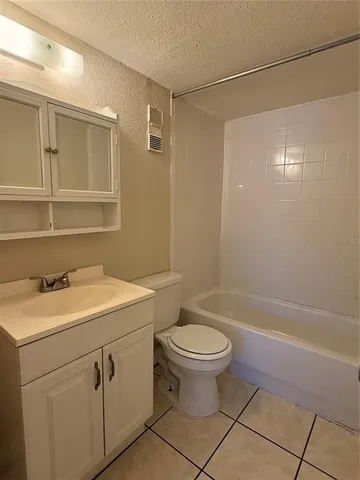 a bathroom with a sink toilet vanity and tub