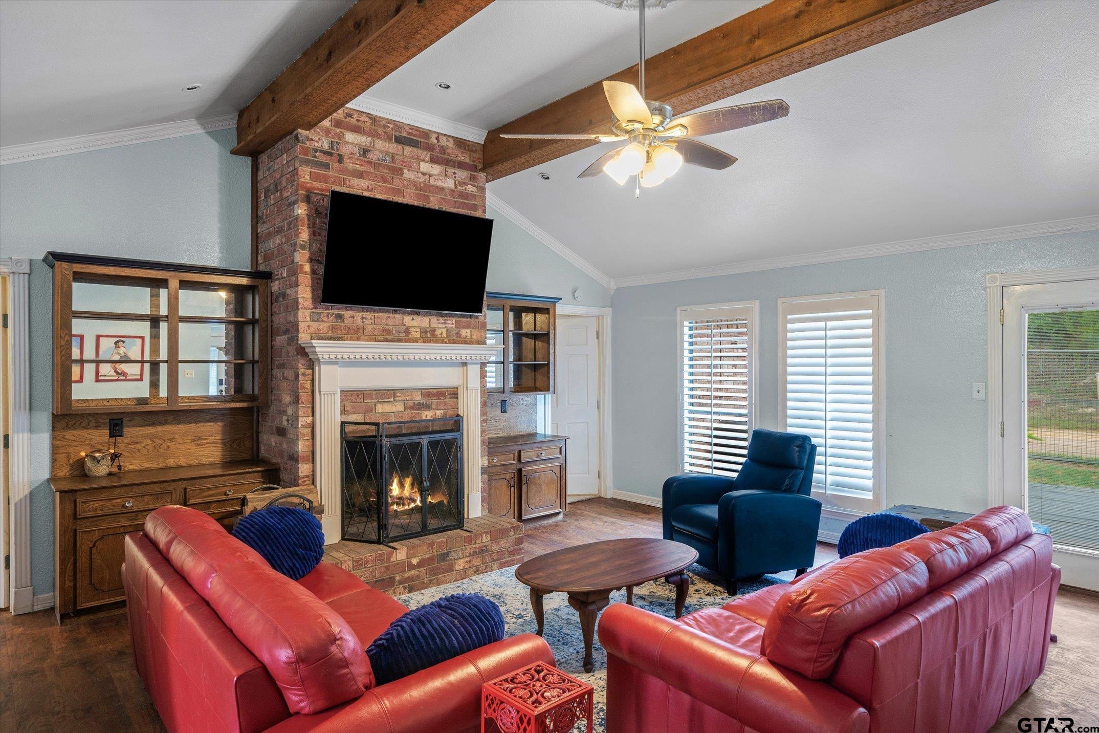 1936 Silver Maple Road Big Sandy, TX 75755 - Photo 11 of 48 a living room with furniture a flat screen tv and a fireplace